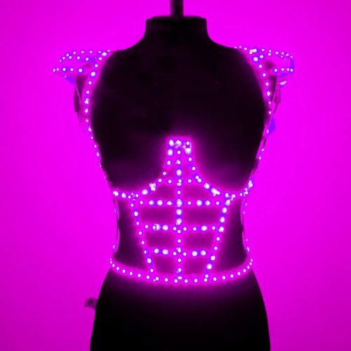 LED cage dress in purple light from side on mennequin