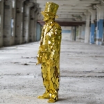 View from sideGold Mirror Man suit with golden cylinder