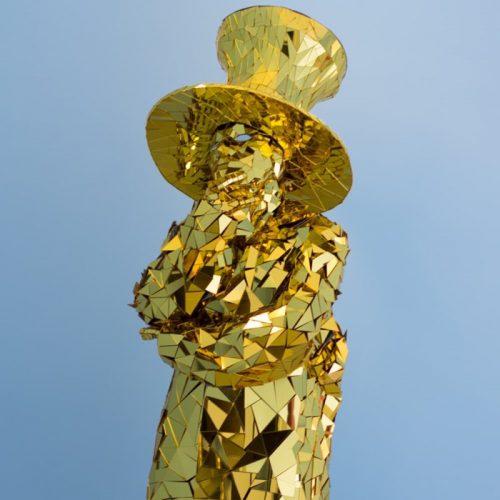 Front view of Golden Mirror man glass suit thinking pose