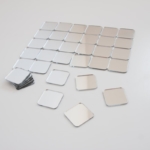 Bulk square mirror tiles making a form
