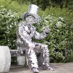 Sitting on the bench Mirror man glass man performance costume