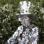 Sitting in the park area in Mirror man glass man performance costume
