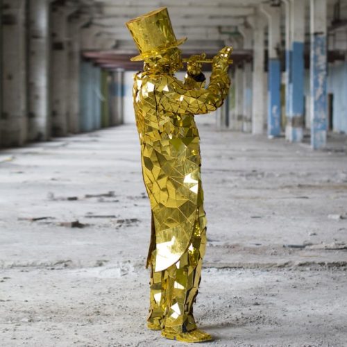 Gold Mirror Man suit with golden cylinder paying on flute