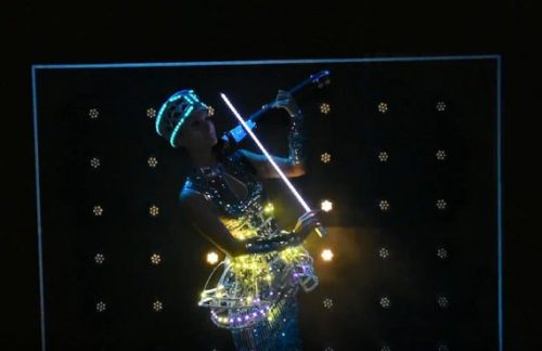 Lady plays on violin wearing into LED smart crset