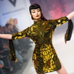 Gold dress costume in action. Model is posing on Avangardista fest in Germany