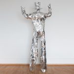 Glitter Sparkly Mirror stilt walker costume near the wall
