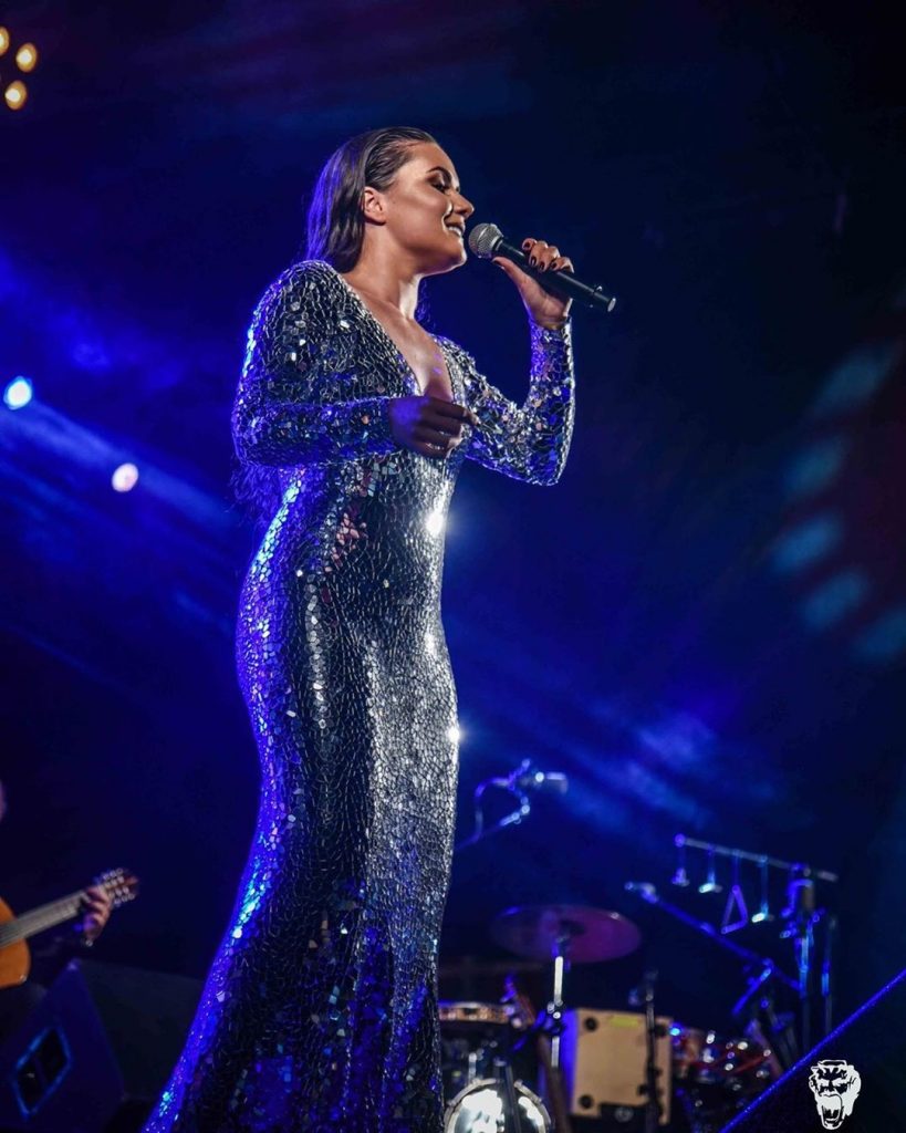 Long evening mirror dress looks stunning in a dim light on stage