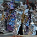 Mirror man "Wizard" costume on Mummers festival playng sax