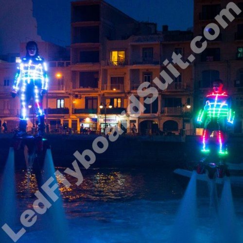 Flyboard duet in LEDs costume fly abowe the river