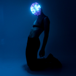 Model on the kneels with LED mask on it