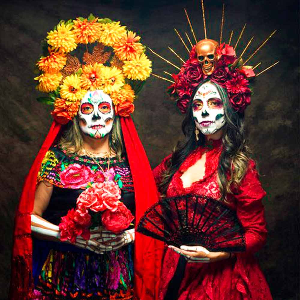 All the mexican symbolls to meet the death – skulls, skeletons, calavera makeup and flowers in day of the dead traditional suits