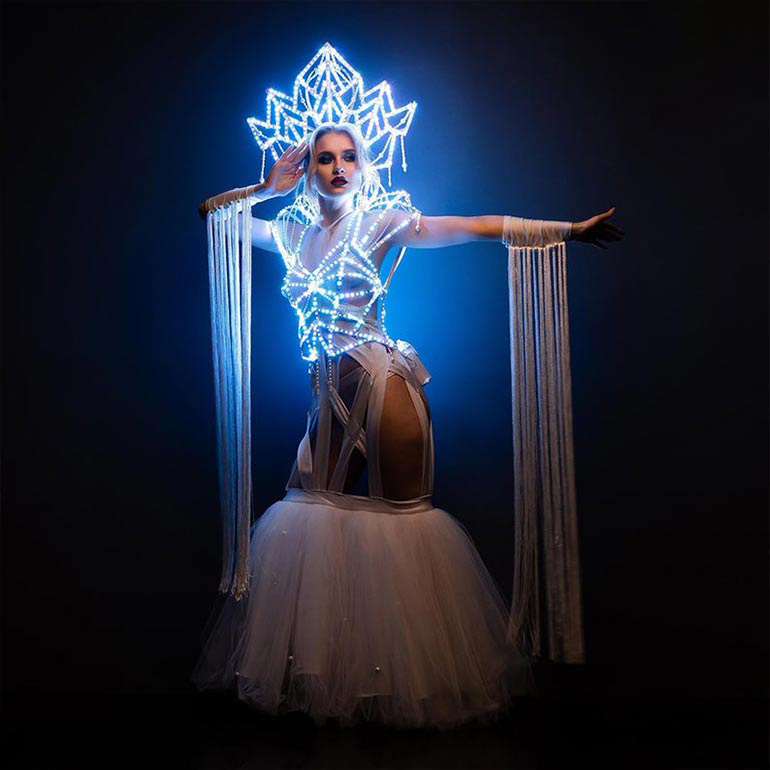 Iridescent LED crown and LED cage bodice with a bold and revealing skirt of this stage Christmas costume