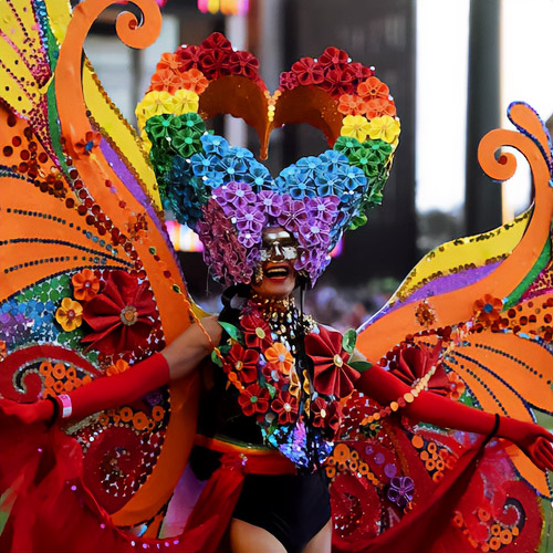 Unusual costume of Women's carnival bodice for the Mardi Gras Festival – huge butterfly wings and stylish horns od LGBT colors