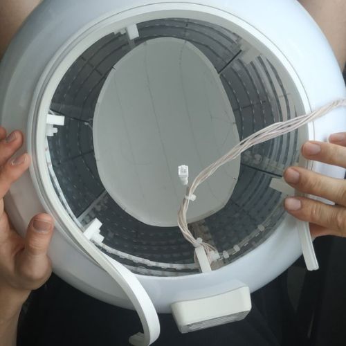 Inserting the head fixture inside the plastic sphere