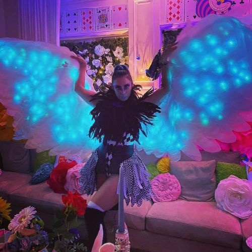 artist in big LED light up wings costume